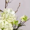 This stunning floral arrangement showcases an artful blend of graceful forms and