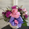 Ceramic container lined with purple and pink filled with beautiful spring blooms