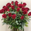 Three dozen roses arranged in a vase with gorgeous greenery will surely