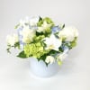 A white glass vase with blue hydrangea, orchids, tulips and viburnum. 

Special