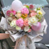 seasonal lush flowers mix with balloons, stylish paper wrap.