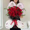 This striking butterfly-shaped bouquet features 24 vibrant red roses, beautifully accented with