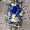 3 ft long dish centerpiece with white spider flowers, daisies, eucalyptus, and