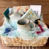 This gourmet gift basket includes a pair of stoneware mugs, several varieties