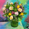 An arrangement made of roses, ranunculus, fillers and greenery 