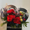 This arrangement is made with roses and chocolates. It is a small