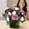 Beautiful modern cube vase with purple roses, purple lisianthus, white spray roses