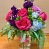 Hot pink roses, purple roses, purple stock, blue hydrangeas and seeded eucalyptus