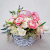 This charming basket bouquet brims with delicate pink roses, creamy white spray