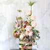This arrangement made with a dozen different shade blush to ivory garden