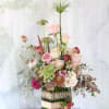 This arrangement made with a dozen different shade blush to ivory garden