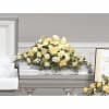 casket spray with yellow carnations, yellow fuji mums and white stock