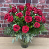 2 dozen stunning red roses arranged in a glass vase accented with