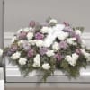 Casket Spray with white satin cross pillow, white carnations, lavender roses, purple