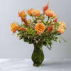 A stunning flower arrangement where delicate white peonies, tender blooms of ranunculus