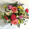 Contemporary bouquet made with a nice selection of flowers. Fun square vase