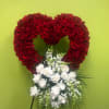  red rose heart with lush white florals and cascading greenery, symbolizing