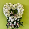This soft ivory and blush floral heart is a symbol of peace