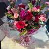 carnations , stock, roses, wax and lilies with a ligth pink basa