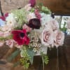 Roses, cymbidium orchids, hydrangea, pink stock, ranunculus, tulips, wax flower, berries, seeded