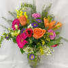This exceptional arrangement of red, yellow, hot pink and purple flowers will
