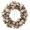 Wreath Standing Spray with green and white daisy poms, peach carnations, peach