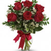 Beautiful ruby red roses in a glass vase.

please let us know if