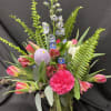 This arrangement is made up of tulips, delphinium, alstroemeria, and carnations with