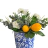 Artificial lemons with eucalyptus and verbena flowers in a blue and white