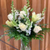 A beautiful vase arrangement featuring white lilies and roses,  this is
