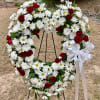 Red roses and white blossoms set among a ring of soothing greens