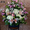 It has white hydrangea, pink roses, lavender daisy, pink asiatic lily