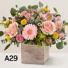 Box flowers with gerbera daisy, roses and yellow button pom
