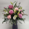 While this wonderful mix of lavender roses, stock, carnations, lilies, limonium and
