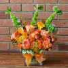 Lush arrangement of tropical pin cushion proteas, mango calla lilies, roses, bells