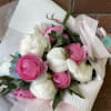 Lovely fresh cut white peonies and pink ranunculus accented with wispy eucalyptus