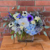 Blue hydrangea, orchids, anemones, spray roses, iris, thistle, eucalyptus and premium fillers