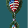 A patriotic floral arrangements with red, white and blue blooms over palm