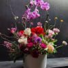 Introducing our stunning Orchid Basket Arrangement, a true showstopper that will elevate