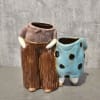 Adorable ceramic flower vase featuring a classic grandma and grandpa dressed in