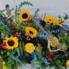 Fresh cut flowers arranged to cover a casket.