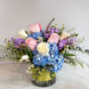 A clear glass cylinder with spring colored flowers! 2 large blue hydrangea