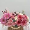 Nestled within a chic handbag are enchanting spring flowers bursting with color