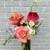Our petite arrangement in a hammered glass vase featuring premium fresh florals.