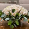 Large low glass cylinder filled with 3 dozen white roses and lush