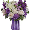 With its dramatic geometric glass vase and bountiful purple blooms, this Mother&#039;s