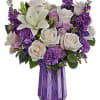 With its dramatic geometric glass vase and bountiful purple blooms, this Mother&#039;s
