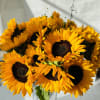 This is a floral arrangement with premium sunflowers and other fillers .