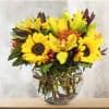 This unique design includes sunflowers, yellow lilies, cymbidium orchids, pin cushion protea