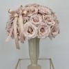 A chic, modern vase adorned with beautiful beige roses, exuding a sense